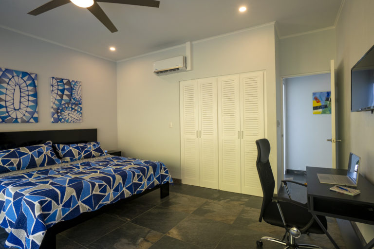 Bedroom 4 - King size bed, large closet, desk, chair, and TV.