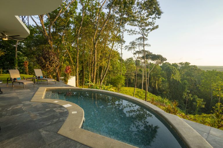 Crescent pool on rear patio with ocean view