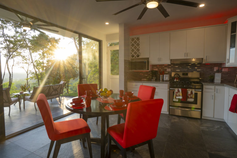 Kitchen with panoramic ocean view and secondary access to parking