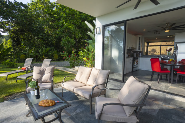 Rear patio off the kitchen, with side yard and parting area