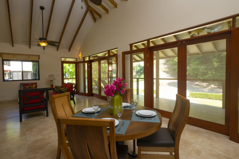 Dining and Living areas have two double-wide doors with screens leading to full-house balcony