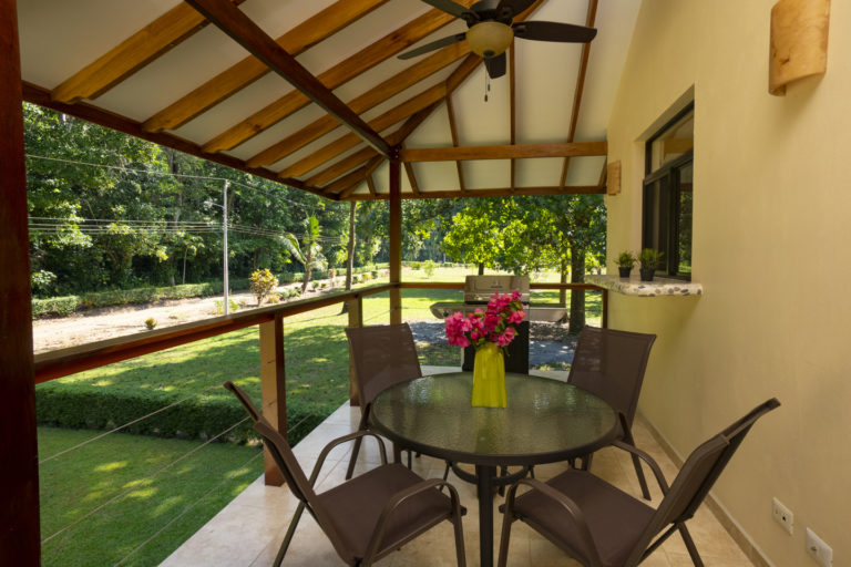Fully-covered large outdoor patio with grill, tables and chairs